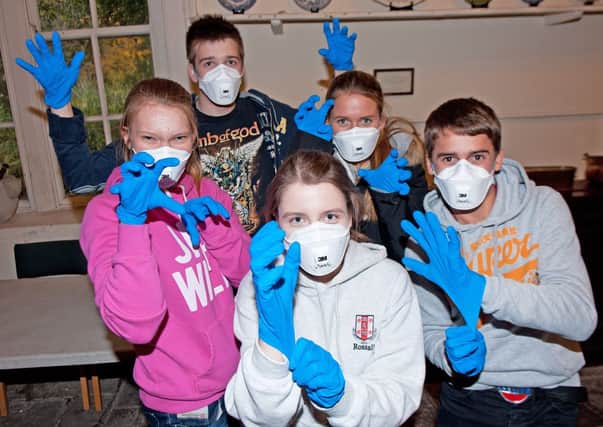 Sixth formers from Rossall School all kitted up with masks and gloves at Lytham Hall.