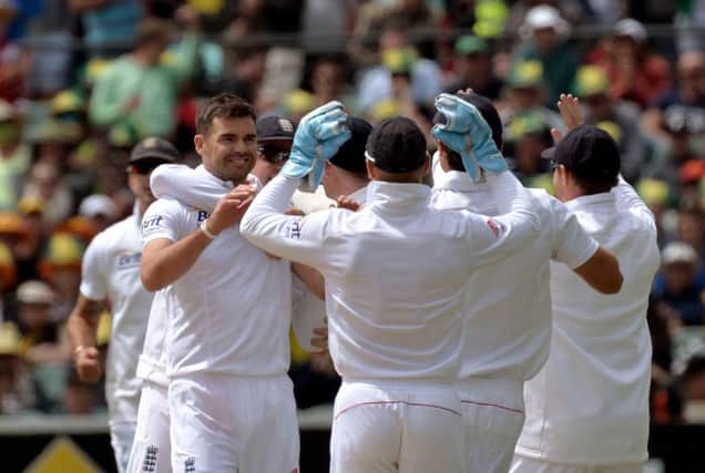 England's James Anderson (left) celebrates taking the catch of Australia's Shane Watson off his own bowling