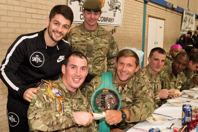 Soldiers pull a cracker and (below) a shot of the packed dining hall.