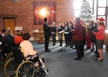 The choir from AKS school perform for staff and patient at Trinity Hospices chapel.