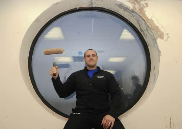 James Wheelhouse decorating his new office at the St Annes YMCA swimming pool.