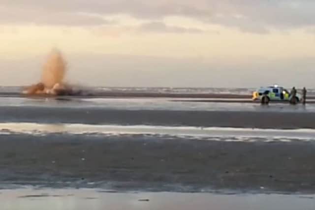 Royal Navy bomb squad detonate a suspected WWII bomb (below) on the beach.