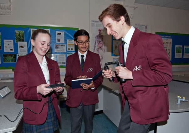 Pupils Jessica Heaton (and below) with Jason Curtis and Jake Howlan, using the equipment the school bought with its prize from the Young Engineers challenge.  Pictures: John McVittie.