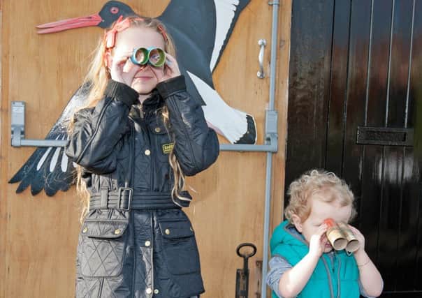 Katie, nine and Harry Williams, three, try out their binoculars.