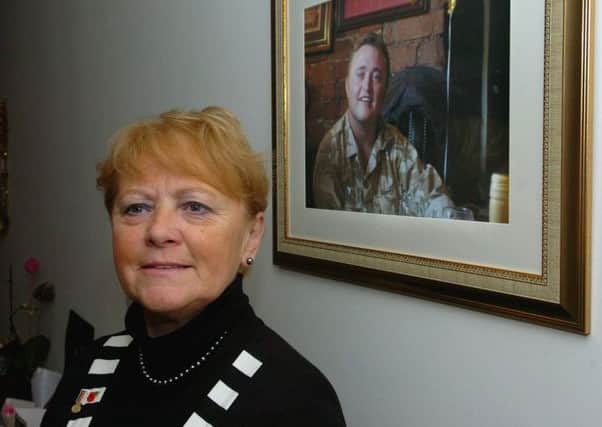 Anne Marlton-Thomas in front of a picture of her war hero son Loren and (below) his widow Nicola who was convicted of fraud.