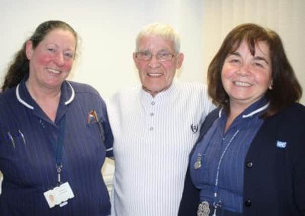 Shelia Dryden and Sue Townson with patient James Harris