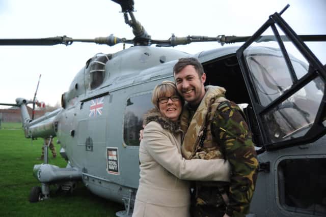 Royal Navy pilot Chris Southworth greets his mum, Shirley Wilson,  after returning to his former primary school, Willows Catholic Primary, in Kirkham.