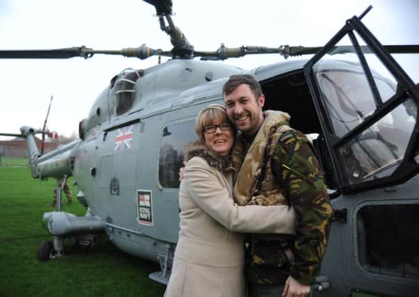 Royal Navy pilot Chris Southworth greets his mum, Shirley Wilson,  after returning to his former primary school, Willows Catholic Primary, in Kirkham.