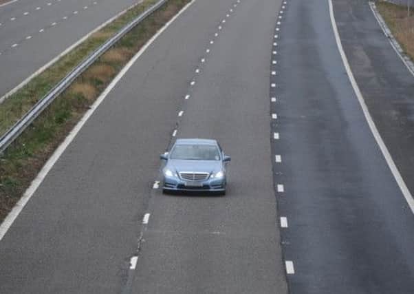 A driver in the middle lane of the M55.