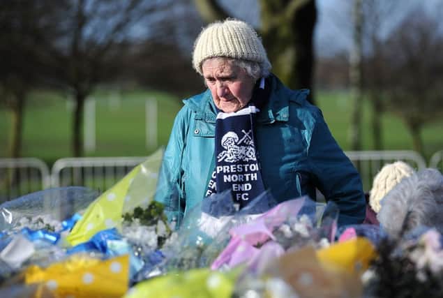 Preston North End fans look at the Tributes outside Deepdale Stadium in memory of Sir Tom Finney prior to his Civic Funeral.