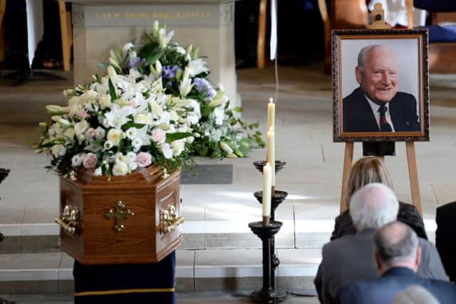 A picture of Sir Tom Finney sits next to his coffin during his Funeral service at St Johns Minster, Preston. PRESS ASSOCIATION Photo. Picture date: Thursday February 27, 2014. See PA story SOCCER Finney. Photo credit should read: Martin Rickett/PA Wire