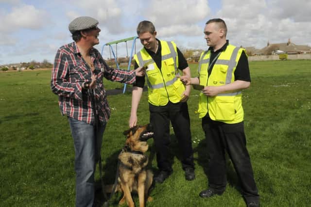 Dog enforcement wardens Joshua Brooking and Gavin Charlton talk to dog walkers.