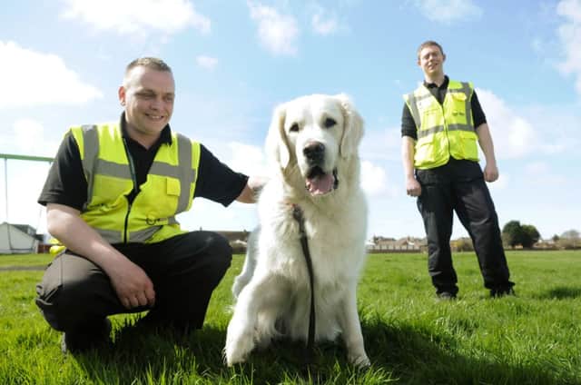 Dog enforcement wardens Joshua Brooking (R) and Gavin Charlton with Blue.
