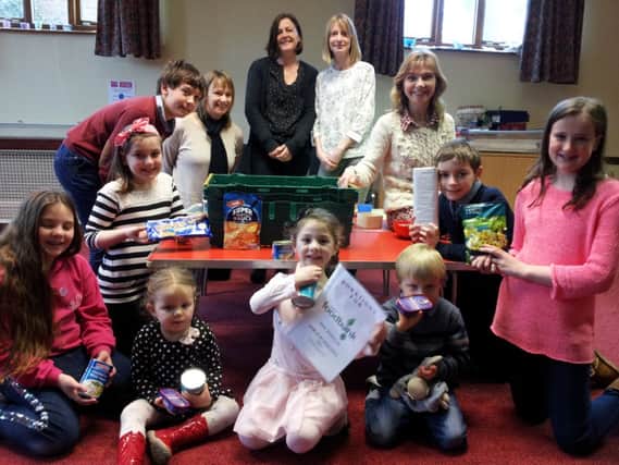 Parents and children from St Margaret's Junior Church starting to collect items for Fylde Food Bank