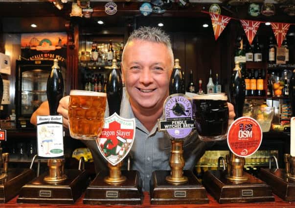 Feature on the re-emergence of dimpled pint glasses in pubs, out of favour since the 1970s but enjoying a new popularity with drinkers. Landlord of the Taps in Lytham Steve Norris with two examples of the dimpled glass.  PIC BY ROB LOCK 1-5-2014