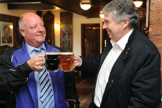 Feature on the re-emergence of dimpled pint glasses in pubs, out of favour since the 1970s but enjoying a new popularity with drinkers.
Customers at the Taps in Lytham with dimpled glasses Mal Bradshaw (left) and Bob Jackson.  PIC BY ROB LOCK
1-5-2014