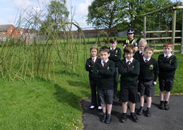 Vandals have destroyed willow sculptures at The Willow's Primary School in Kirkham.  Pictured are some of the children with PC Charlie McDonald.