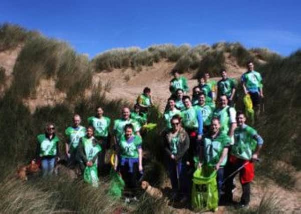 Spring clean: A team from McDonalds helping clear rubbish from the sand dunes in St Annes