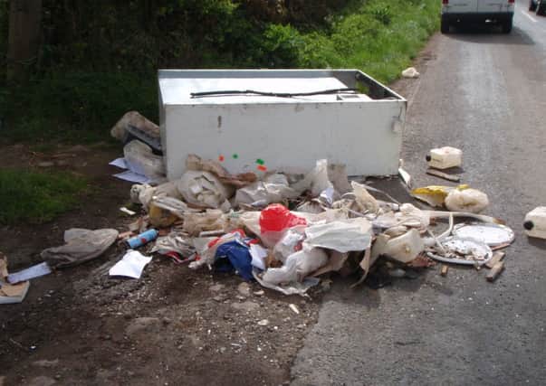 Highly dangerous The fridge freezer and rubbish bags left dumped on a main road near Preston