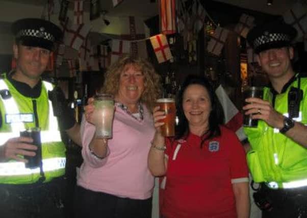 Cheers to a peaceful World Cup: enjoying a soft drink are,  from left, Pc Michael Schouteten; Councillor Cheryl Little; Emma Willders, landlady at   the Lord Derby in St Annes and vice-chair of Fylde Pubwatch; Pc Stewart Marshall.