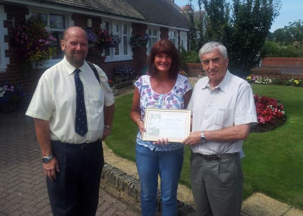 Carolyn Laver of St Patrick's Road North receives her gold certificate for the best front garden in St Annes 2013 from North West In Bloom judges, Mel Kirby and John Bilsborough