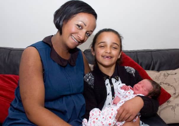 India Faulkner with her daughter Jazmine, seven, who delivered her new baby sister Saffron Grace.
