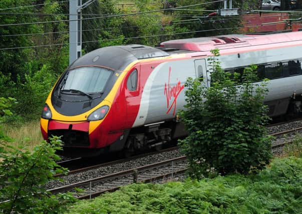 File photo dated 15/8/2012 of a Virgin train, as Virgin Trains today promised to increase capacity on the West Coast mainline after it secured a deal to continue running the franchise until March 2017. PRESS ASSOCIATION Photo. Issue date: Thursday June 19, 2014. The operator said there will be "significant improvements" for customers with the introduction of free superfast WiFi, more seats and new services. See PA story CITY Virgin. Photo credit should read: Rui Vieira/PA Wire