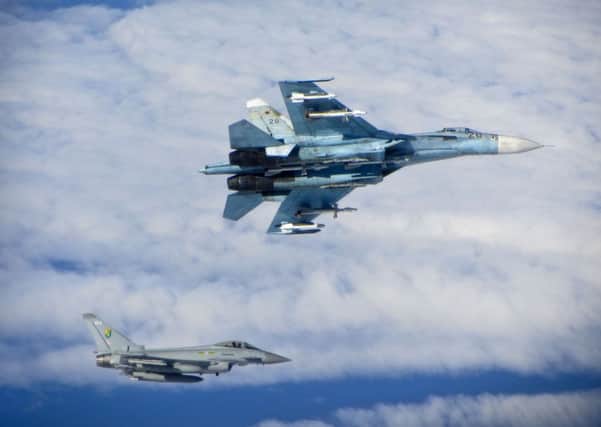 Air watch: A Warton-built RAF Typhoon shadows a Russian Su 24 while on patrol duty over the Baltic states