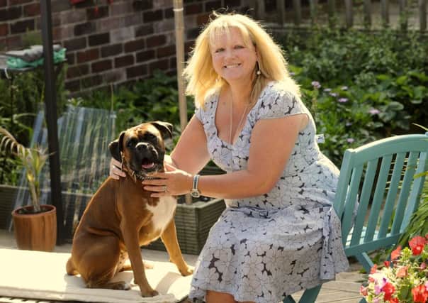 Four-legged fund-raising: A dog walk will form part of Lee Reynolds mission to raise £5,000. She is pictured with her boxer Beanie Balboa