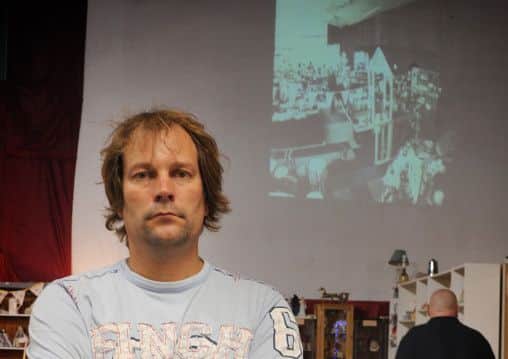 To catch a thief: Rick Taylor, who owns the Regent antiques market on Church Street in Blackpool, is projecting CCTV footage of a shoplifter on the former cinemas screen in a bid to catch the thief