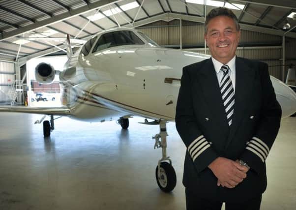 Managing Director Simon Menzies next to the company's £4 million executive jet.