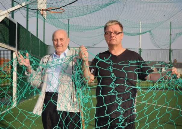 Play fears: Roy Boyes and Len Woods are concerned at the deteriorating state of the multi-use games area on Fishers Field in South Shore. Len (left) and Roy highlight the loose and low hanging netting