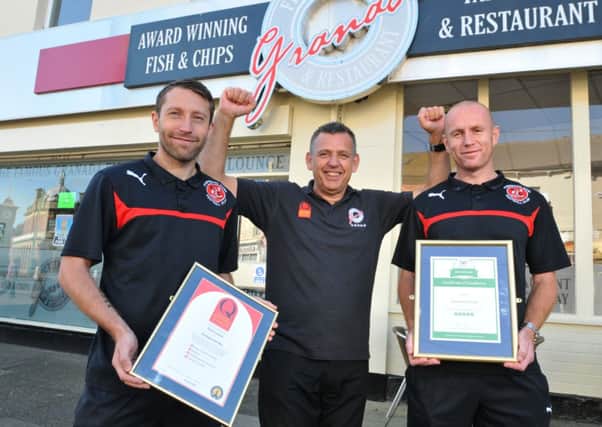 Steve Lynton of the Granada Fish Bar in Fleetwood has won a trip advisor and a Quality award, celebrating with Stephen Dobbie and Stephen Crainey of Fleetwood Town