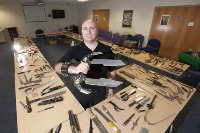 Lethal weapons Sgt Scott Archer with some of the blades handed in as part of Lancashires knife amnesty