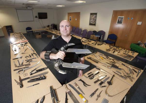 Lethal weapons Sgt Scott Archer with some of the blades handed in as part of Lancashires knife amnesty
