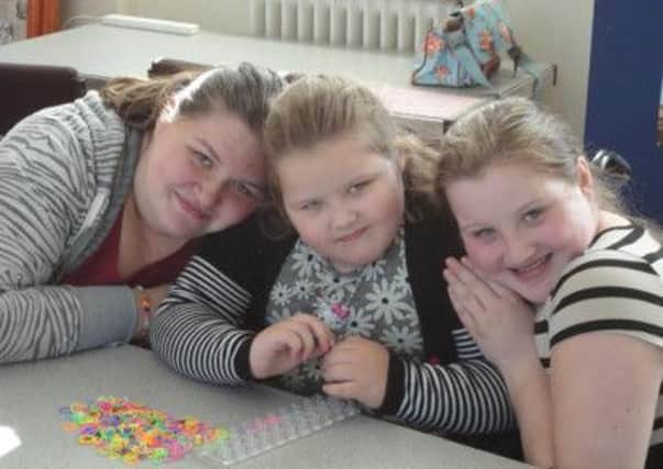 The Poyner sisters, Katie, 10, Louise, 15 and Lily, seven, who help mum Sarah look after dad Chris