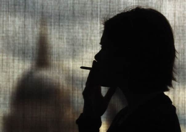 Stoptober: A woman smoking as thousands of smokers are stubbing out their last cigarette as they join a mass quit attempt which begins today