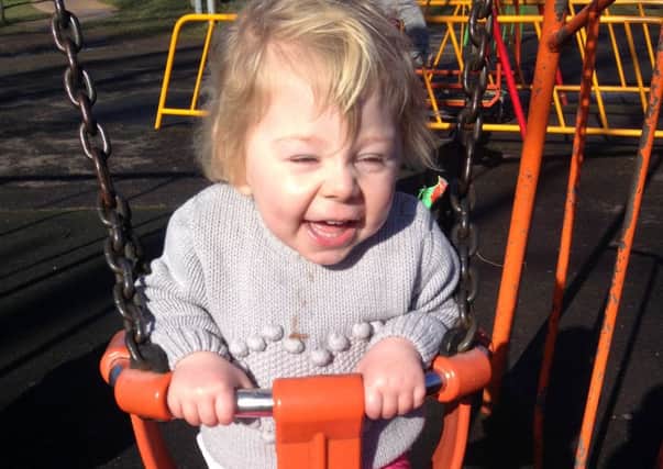 Happychild: Kacey Hambleton pictured playing in a swing. Below, Connor Gibson