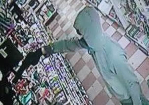 CCTV image showing a man holding a gun who attempted to rob the Londis store on Rossall Road, Cleveleys.