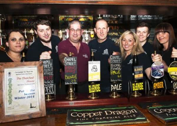 Brilliant beer: The Thatched House at Poulton Landlord Vin Hamer and his team are presented with the  winter pub of the season from CAMRA