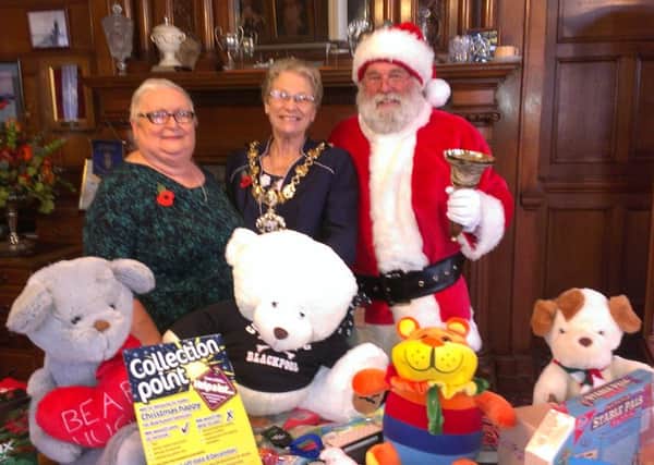 Season for giving: Blackpool Mayor Coun Val Haynes, accompanied by her consort Alan Haynes dressed as Santa, and  Coun Pamela Jackson at the launch of this years Give A Little campaign