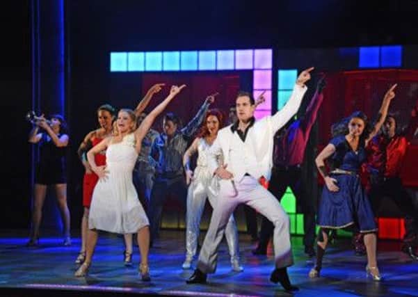The cast of Saturday Night Fever strike a pose