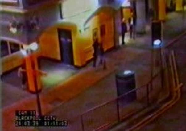 On camera: The CCTV image captured in November 2003, outside a Blackpool bar shows a woman police are looking to trace, with a young girl they believe may be Charlene Downes