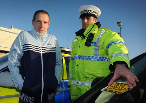 instant message: Police in Blackpool are getting across their Christmas Dont Drink and Drive message across by putting a letter about the campaign inside old-style fixed penalty yellow envelopes and attaching them to vehicles in pub car parks. Pictured are the Swift Hound  General Manager Neil Sharrock and PC Adam Dawson from West Roads Policing Department