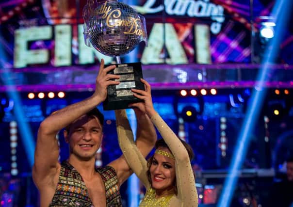 Pasha Kovalev and Caroline Flack holding aloft the winners trophy after being named the top two in Strictly Come Dancing 2014