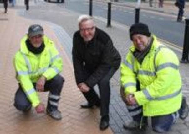 Clean up: Coun John Jones inspects some of the town centres pavements