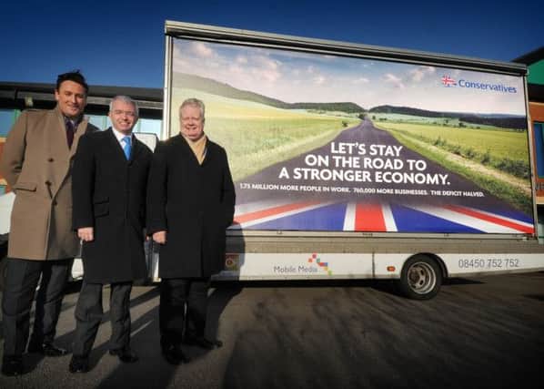 From left, Peter Anthony, Mark Menzies and Eric Ollerenshaw with the campaign poster