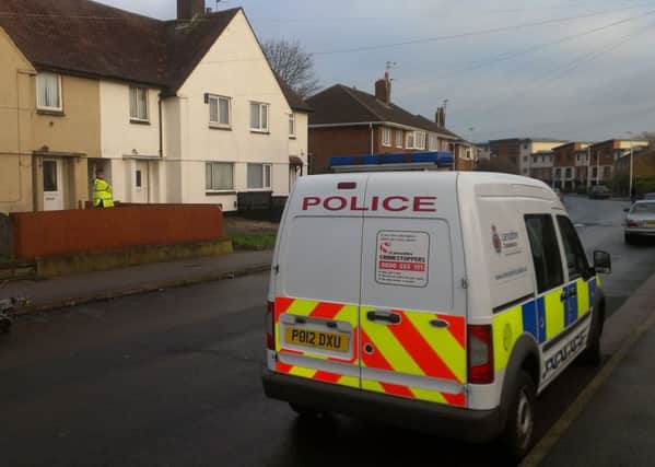 Crime scene: A police officer stands near the front garden in Dinmore Avenue where a stabbed woman was found