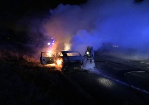 A firefighter tackles a blaze at the side of the M55. Photo: Lancs Police.