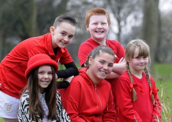 Scarlet for Scarlett day as children from The Willows Catholic Primary School wear red to raise money for fellow pupil Scarlett McCracken.  She is pictured centre with William Melling, Declan De Santi, Theresa Boylan and Maisie Brook.